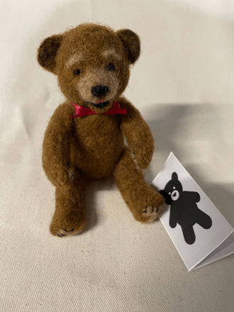 A needle felted teddy bear to express concern for someone going through a difficult time.