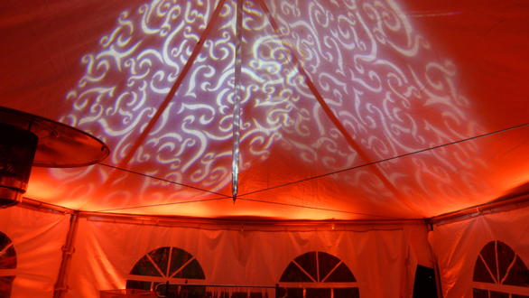 Tent wedding lighting. Up lighting in red with gobo pattern on the ceiling.
