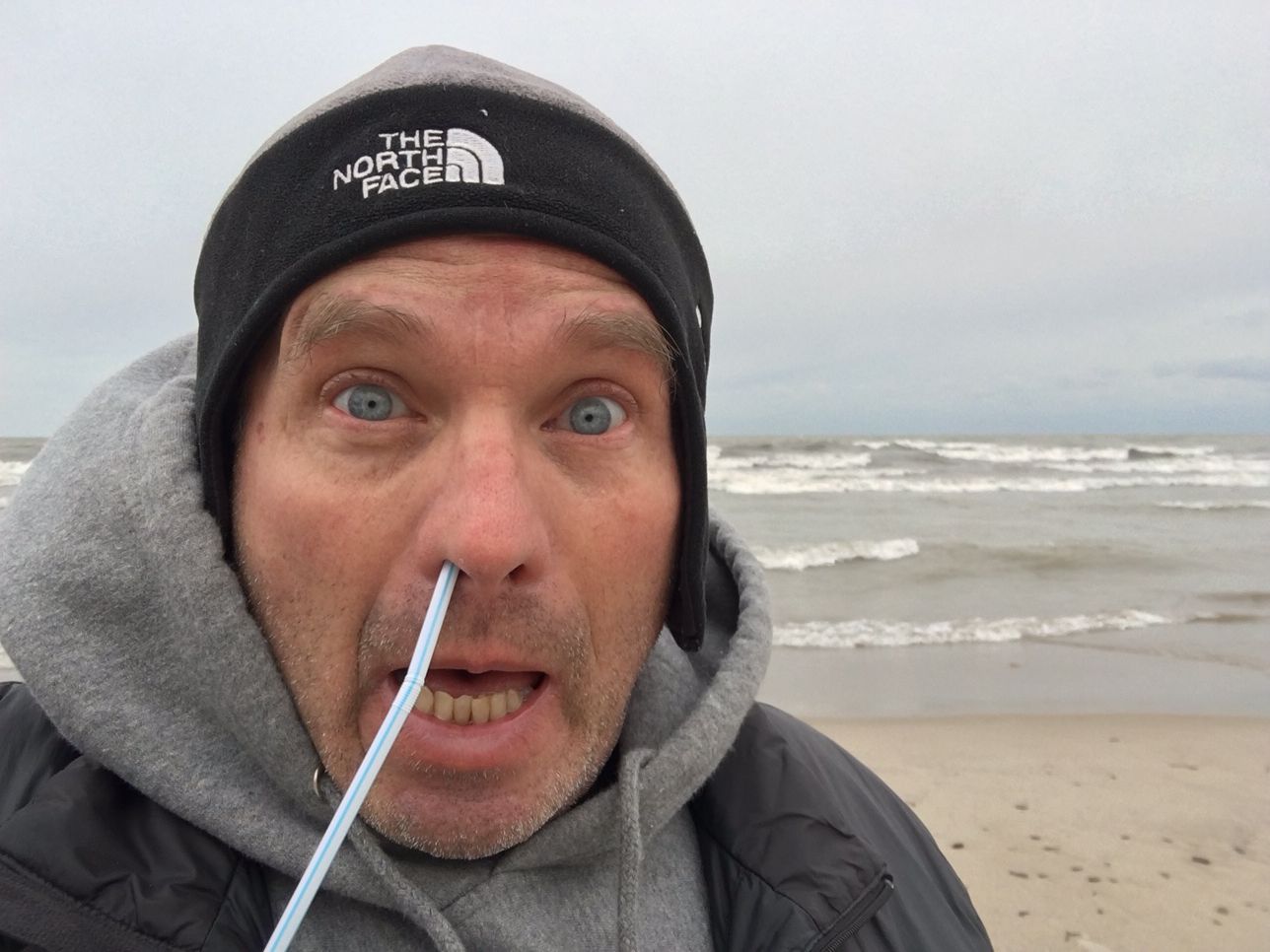 Marty on beach with plastic straw stuck in his snout.