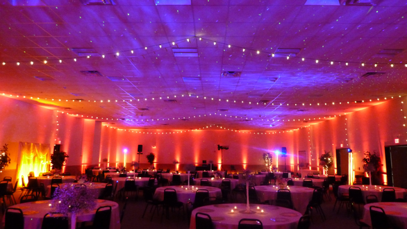 A sunset wedding theme at the AAD Shrine with red up lighting, bistro and stars with Northern Lights on the ceiling.