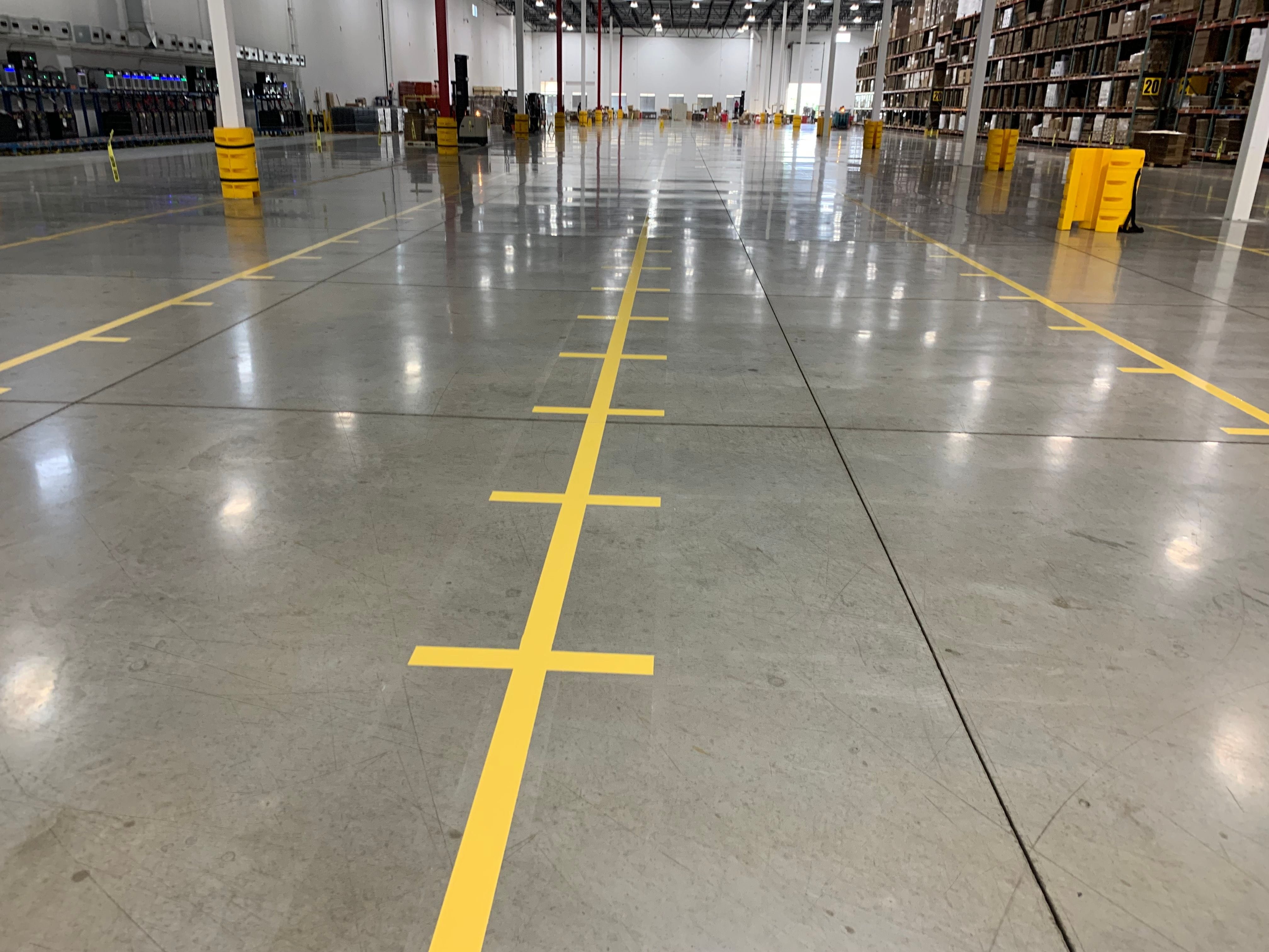 yellow bin location markings in warehouse
