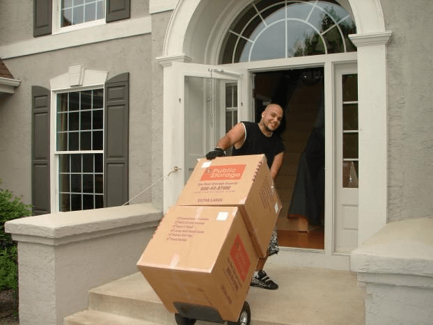 Mover wheeling boxes into home