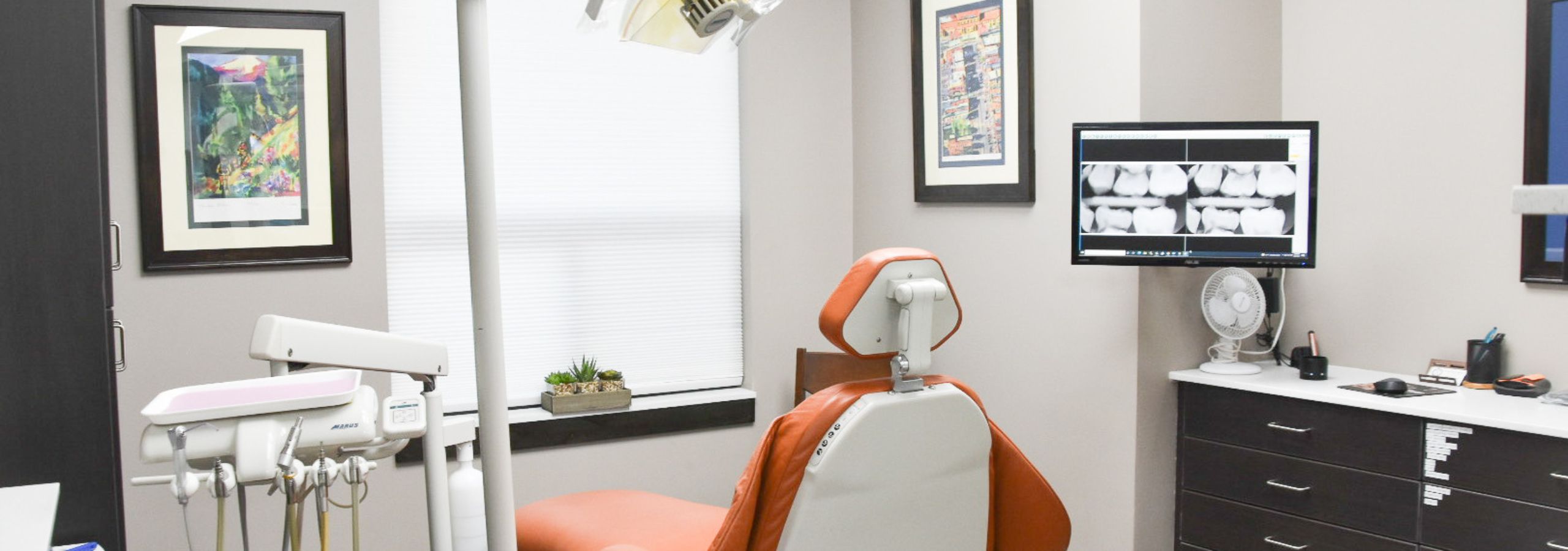 Image of the inside of the dental office for Mt. Ogden Dental & Implant Clinic; an exam room and dental chair is shown.