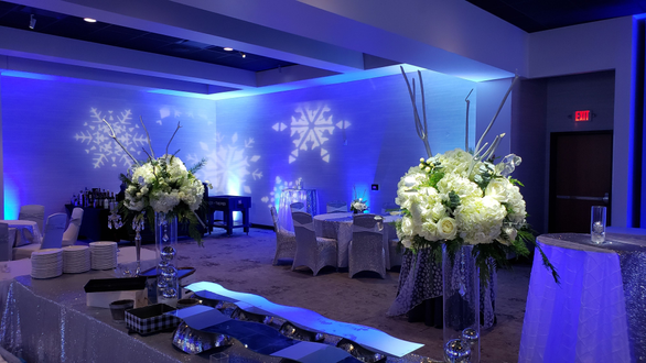 Winter theme at Pier B. Up lighting in blue and ice blue with pin spots on flowers. decor by @thevaultduluth