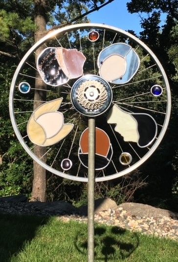 garden art,multi-cultural heads,bike wheel