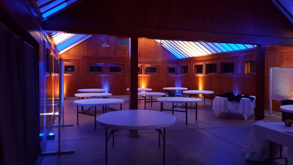 Park Point Beach House wedding lighting with blue and yellow up lighting by Duluth Event Lighting.