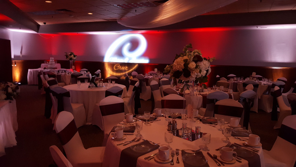 Red and white up lighting at Blackwoods Event Center in Proctor. Wedding monogram