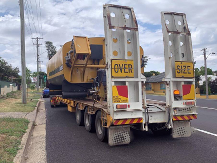 alt= "Image of a trailer hauling oversize vehicle"