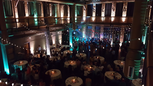 Up lighting in mint green and soft white at Clyde Iron Works for a wedding.