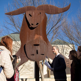 Instructor Robert Scafe with OU students discussing the sculpture The Sacrifice of Isaac by Menasche Kadishman at the Fred Jones Jr. Museum ofArt