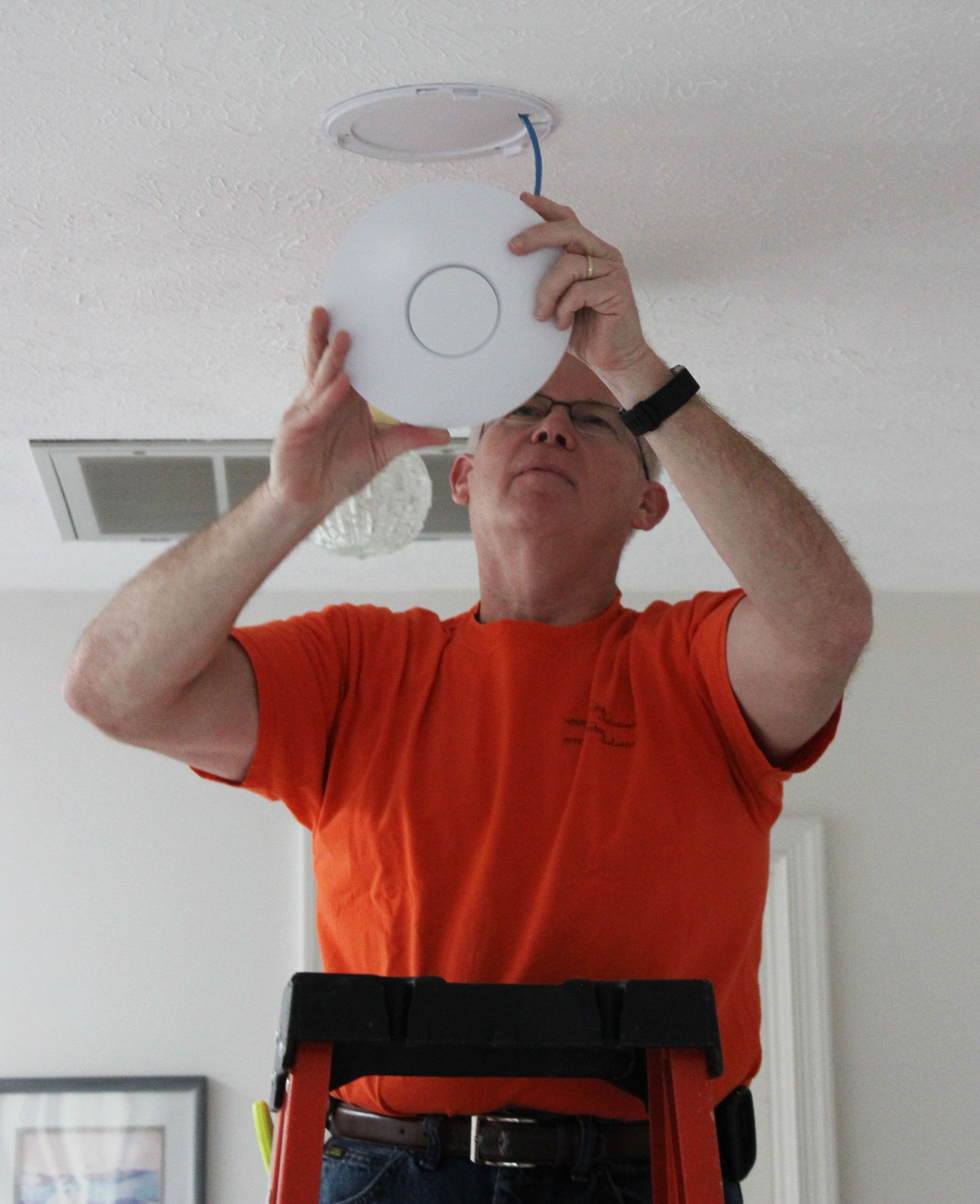 Installation of a Ubiquiti Networks Wi-Fi access point in a home.