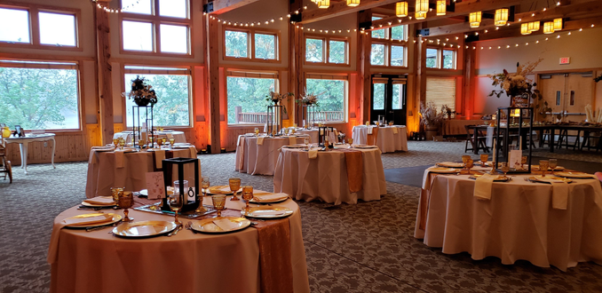 Heartwood Event Center in Trego. Wedding lighting fall colors of red, amber and sunset orange. Bistro on the ceiling.