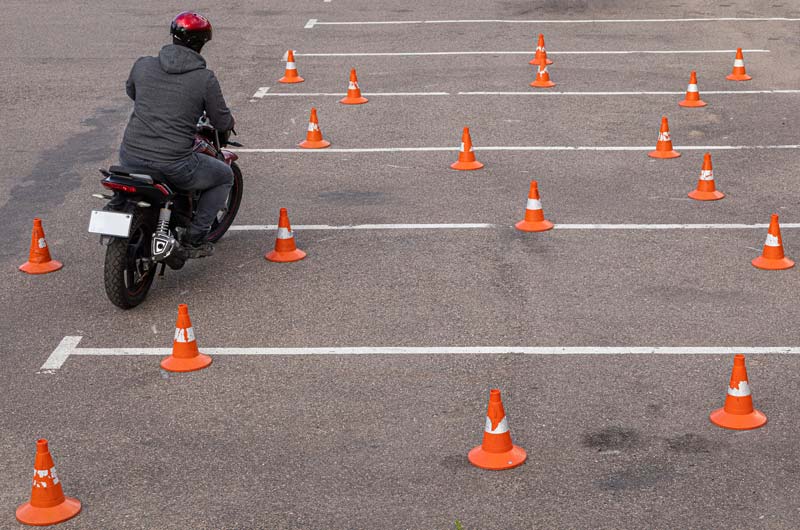 Man on Motorcycle Practicing with Traffic Cones