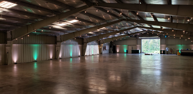 Wedding lighting at the Lake County Fairgrounds. Up lighting in mint green and soft white by Duluth Event Lighting.