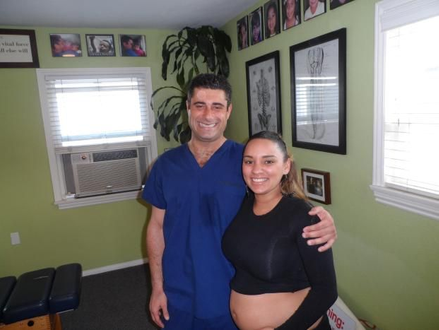 Dr. Biscotti of South Bay Family Chiropractic is performing chiropractic care for pregananant client in this photo.