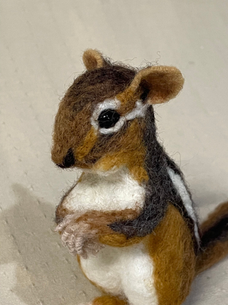 Felted chipmunk acting innocent about the damage he has done.