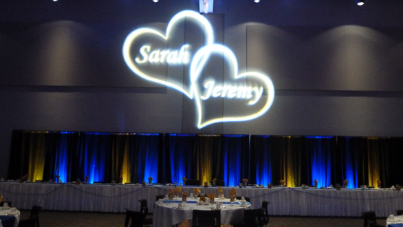 Wedding lighting in blue and yellow. Monogram on the wall at Black Bear Casino