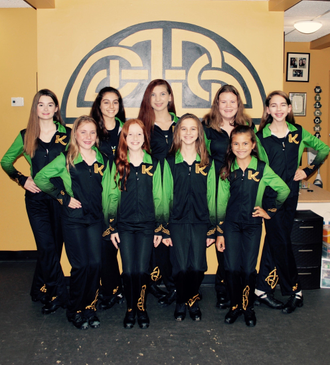 Custom sublimated Celtic and Highland Dance Warm-up. Kelly green with golden yellow, black. Detailed movement graphics compliment jacket and pants.