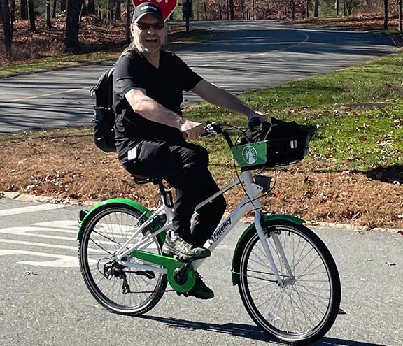 Employee riding fidelity bike at corporate campus