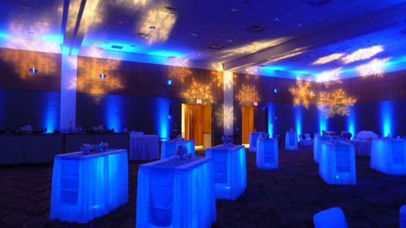 Wedding lighting in the Horizon Room. Blue up lighting with snowflakes on the ceiling. Glowing Cocktail tables.