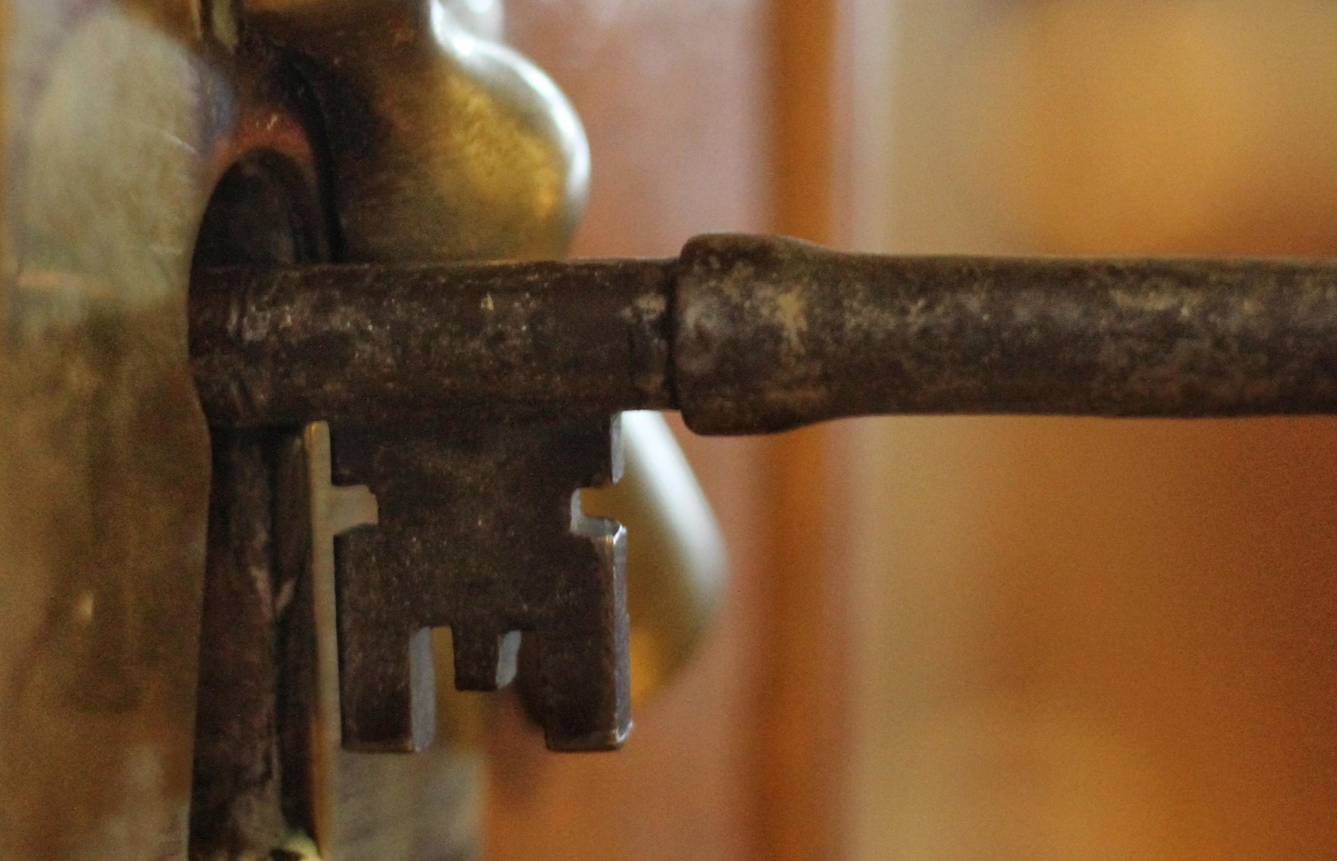 Old-fashioned key unlocking a door