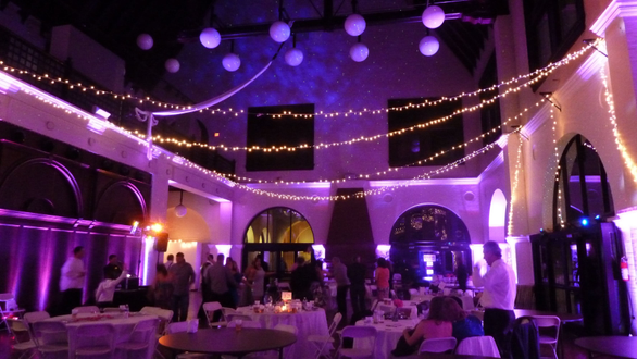 A Duluth Depot wedding with pink up lighting and stars on the very tall walls.