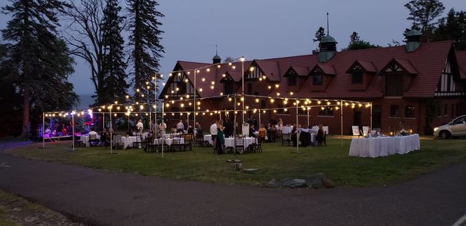 Glensheen carriage House lawn with a bistro tent for a wedding.