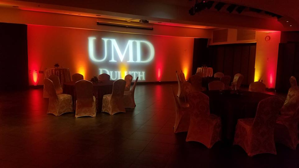 UMD event. Up lighting in red and gold with logo
