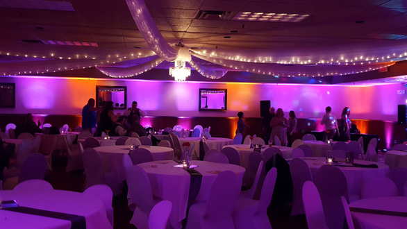 Wedding lighting at Blackwoods Proctor Event Center. Up lighting in magenta and orange.