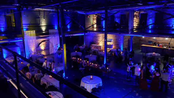 Wedding reception lighting in a blue and champagne color. Clyde Malting Building. lighting by Duluth Event Lighting