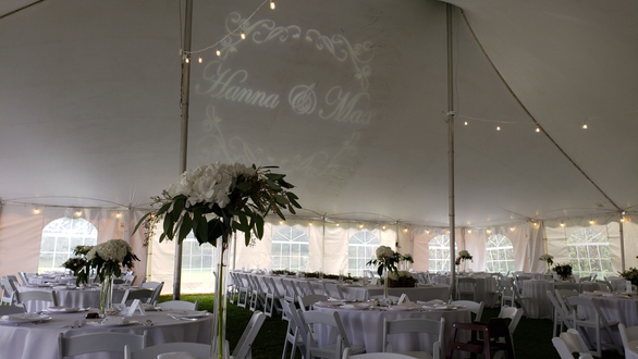 Tent wedding lighting. bistro and a wedding monogram over the head table.