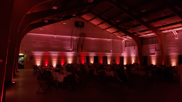 Wedding lighting at the Cloquet Armory in a peach and a dim red. Lighting by Duluth Event Lighting