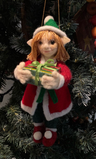 6.5" Needle felted Female Elf with felt skirt and hat, carrying a wrapped present.
