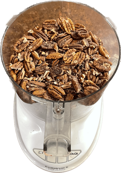 Looking down on food processor with roasted pecans
