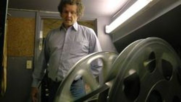 Brian rewinds the movie using a machine called a MUTT. During showtime the filmstrip was pulled off one side of the mutt through a series of tension pulleys.