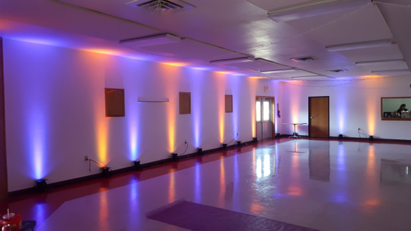 Orange and purple up lighting for a wedding at the Billings Park Civic Center by Duluth Event Lighting.