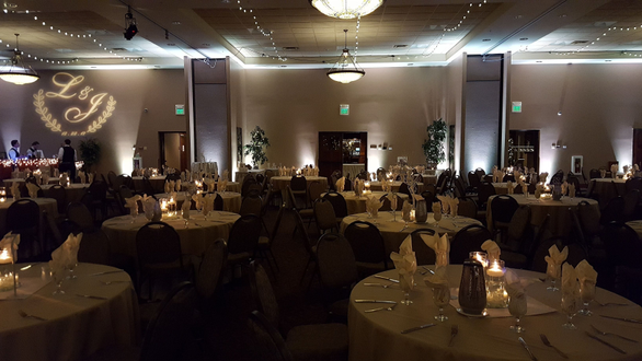 Timberlake Lodge, Grand Rapids. Wedding lighting in champagne white. Glowing Cocktail tables, wedding monogram, bistro
