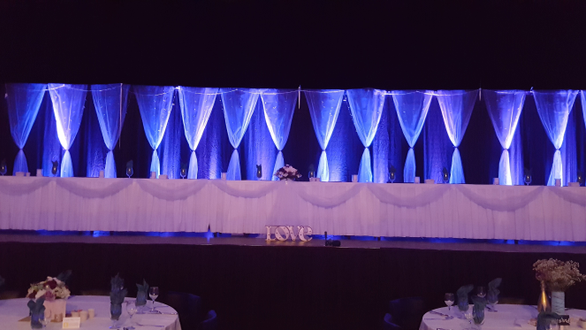 Wedding lighting at Black Bear Casino. Head table on the stage.