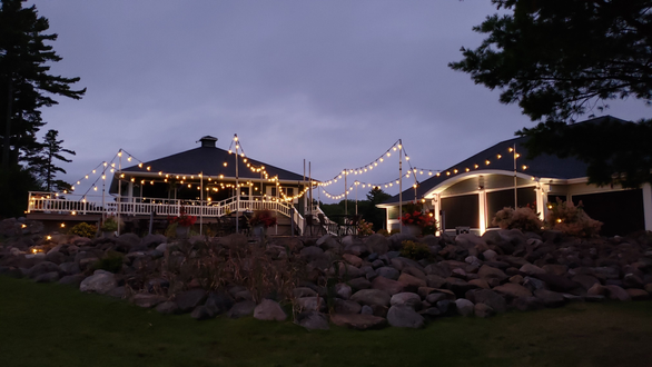 Apostle Highlands Golf Course, Bayfield. Bistro lights on the patio. Up lighting in warm white.