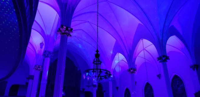 Wedding lighting at Sacred Heart with blue and purple up lighting. Stars and Northern Lights dancing on the ceiling.