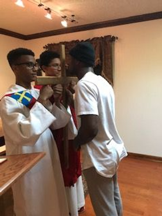 Men Holding A Cross