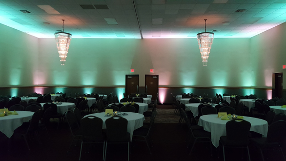 Mint green and soft white up lighting for a wedding at Barker's Island