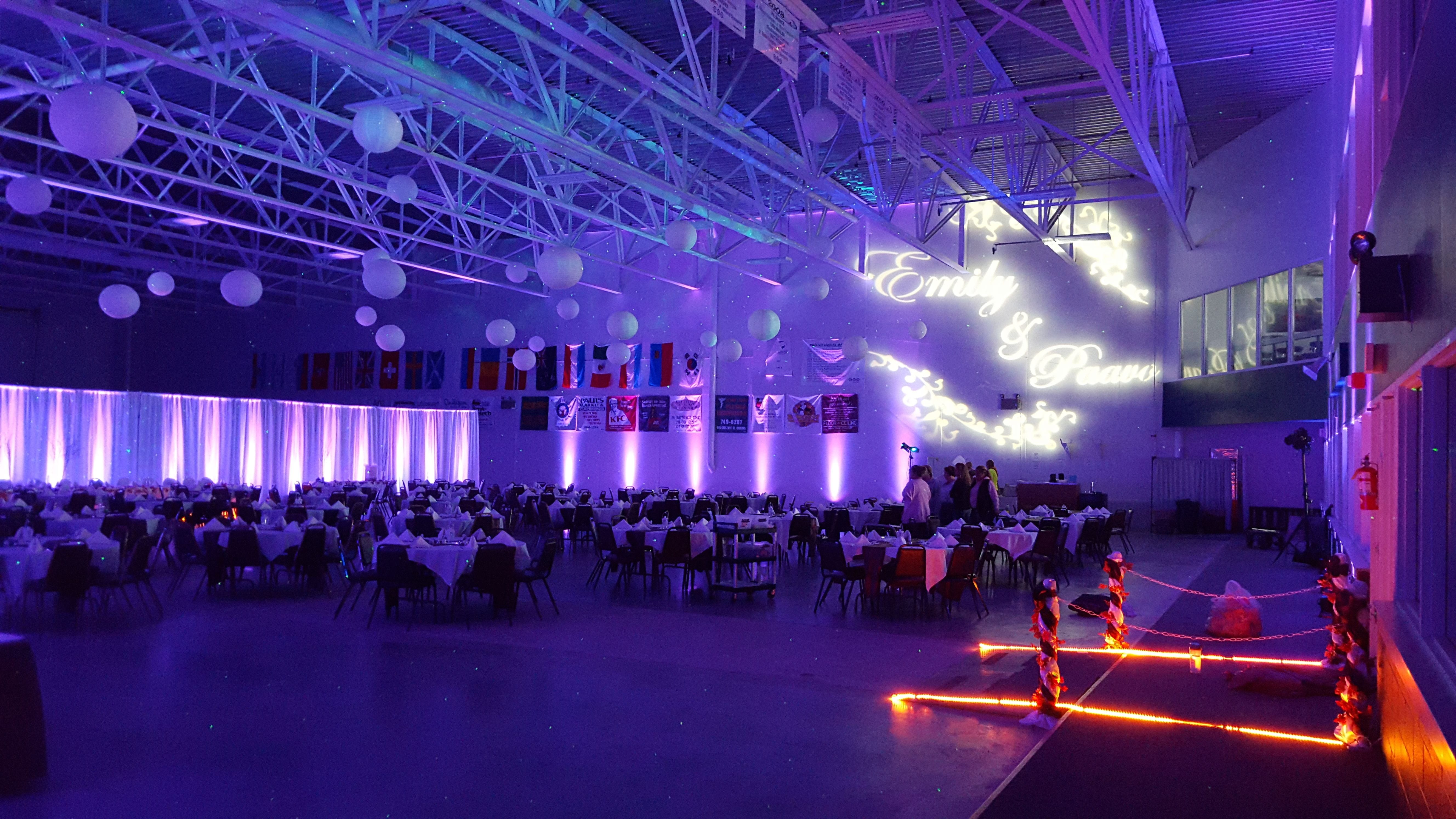 Wedding lighting at the Eveleth Curling Club. Up lighting in lavender purple with wedding monogram.