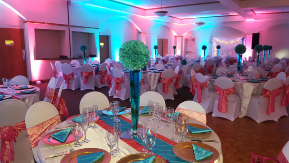 Teal and coral up lighting for a wedding at Cedars Hall, Minnepolis.