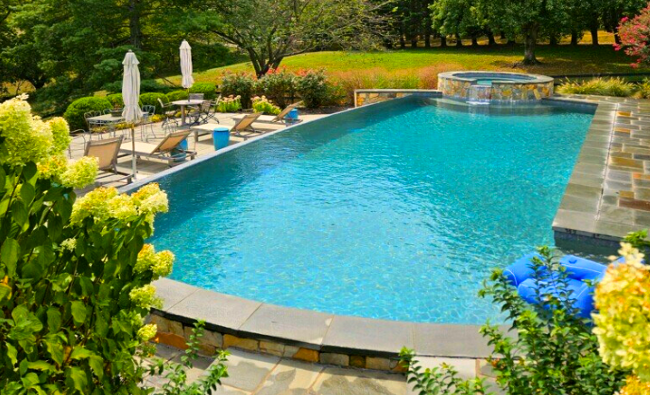 Great Falls pool with infinity edge, and spa overflowing into pool.