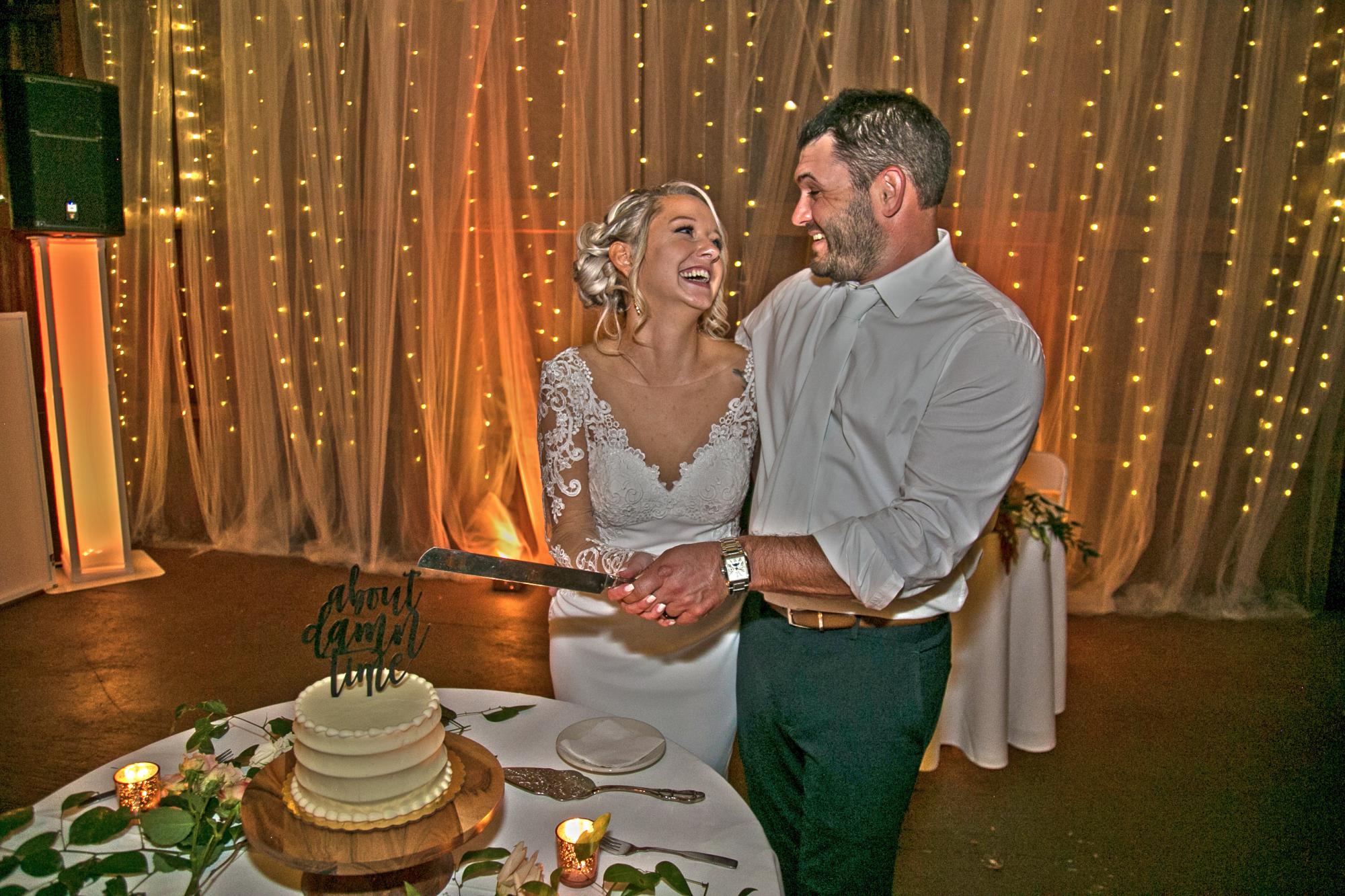 Bride and Groom cut the cake at their wedding reception.