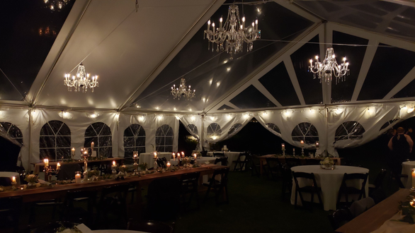 Tent wedding lighting. dimmable perimeter bistro with four chandeliers.