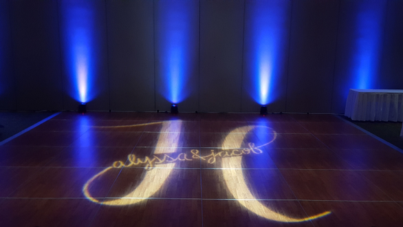 Wedding lighting at Black Bear Casino. Wedding monogram on dance floor.