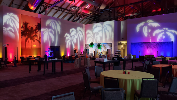 Beach Theme Party with palm tree and backdrop lighting by Duluth Event Lighting. Decor by Event Lab.