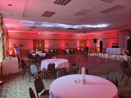 Wedding lighting of blush pink and red in the lower room at the Heartwood Event Center in Trego.